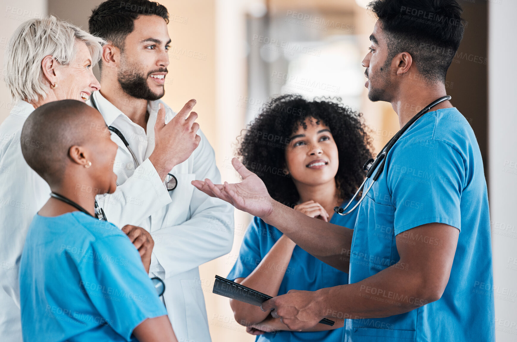 Buy stock photo Shot of a group of young doctors having a discussion in a modern office