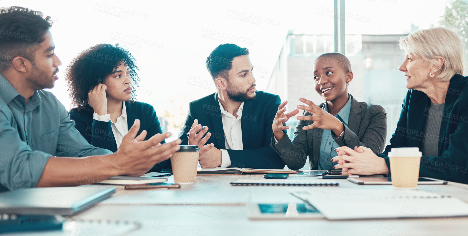 Buy stock photo Shot of a diverse group of businesspeople sitting in the office together and having a meeting