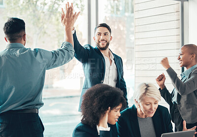 Buy stock photo Shot of a diverse group of businesspeople celebrating a success during a meeting in the office