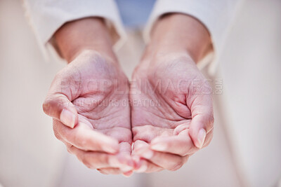 Buy stock photo Shot of an unrecognizable person holding out their hands outside