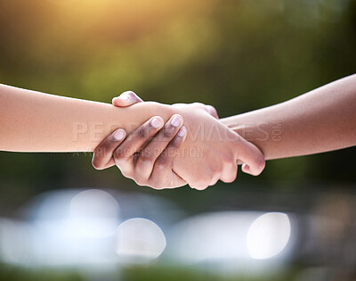 Buy stock photo Shot of two unrecognizable people holding hands outside