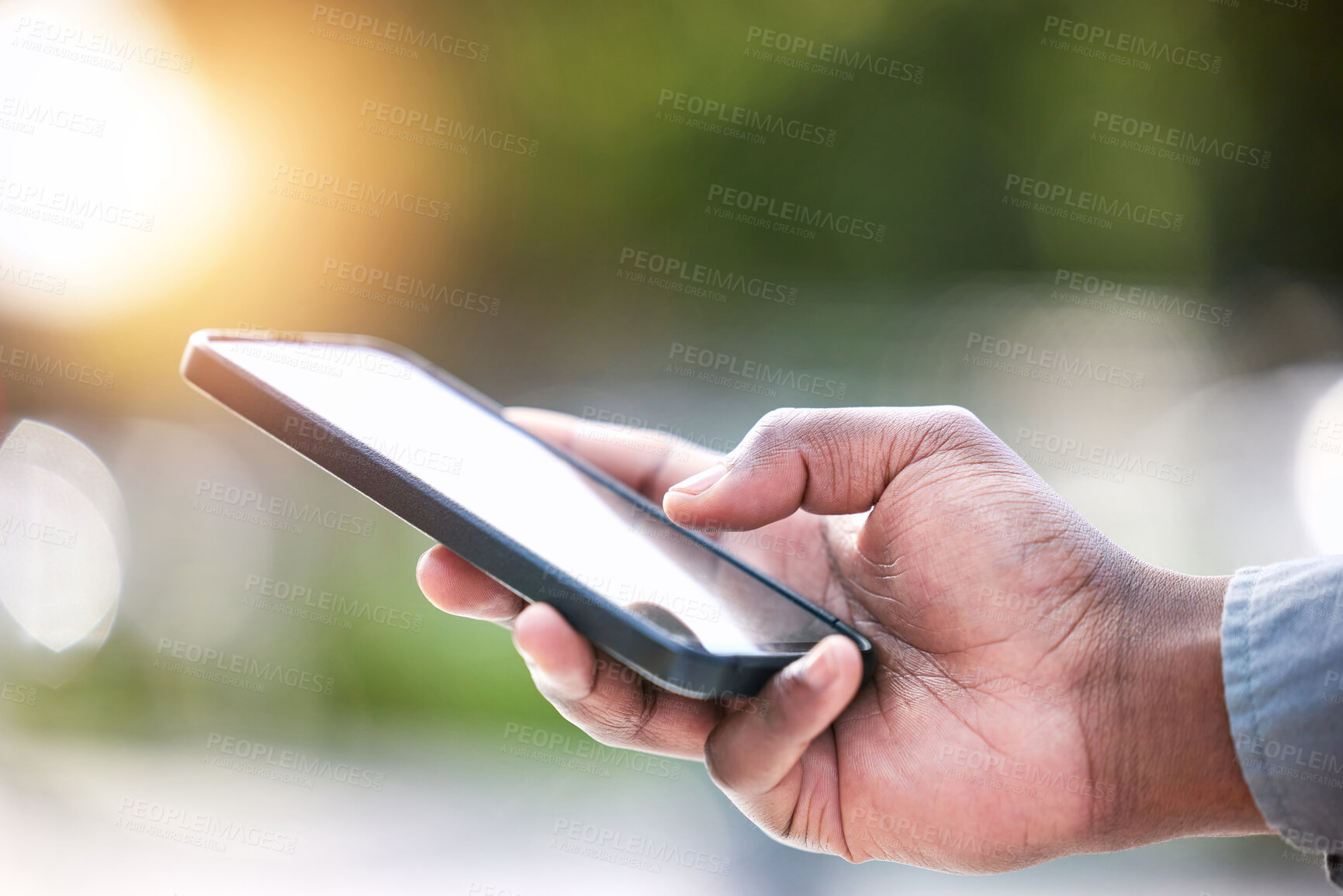 Buy stock photo Shot of an unrecognizable businessperson using a phone outside