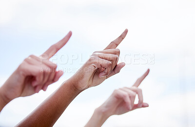 Buy stock photo Shot of a group of unrecognizable people pointing their fingers outside