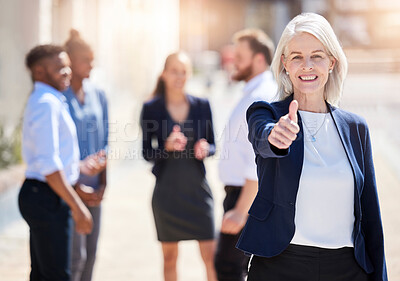 Buy stock photo Shot of a mature businesswoman showing a thumbs up outside