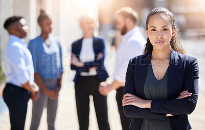Buy stock photo Shot of a young businesswoman standing with her arms crossed outside