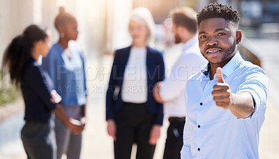 Buy stock photo Shot of a young businessman showing a thumbs up outside