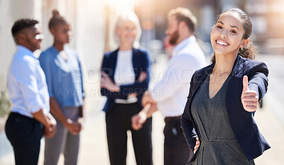Buy stock photo Shot of a young businesswoman showing a thumbs up outside