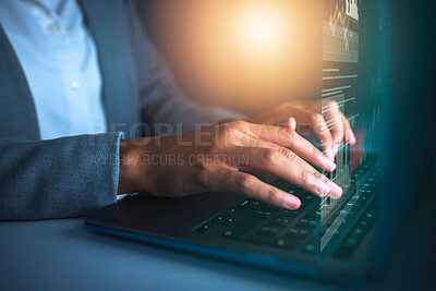 Buy stock photo Cropped shot of an unrecognisable businesswoman sitting alone in the office and using her laptop