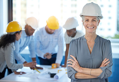 Buy stock photo Shot of a mature businesswoman standing with her arms crossed in an office at work
