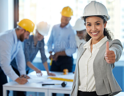 Buy stock photo Shot of a young businesswoman showing a thumbs up at work