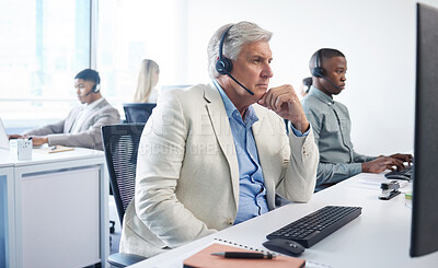 Buy stock photo Portrait of a mature businessman using a headset and computer in a modern office