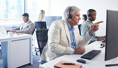 Buy stock photo Portrait of a mature businessman using a headset and computer in a modern office