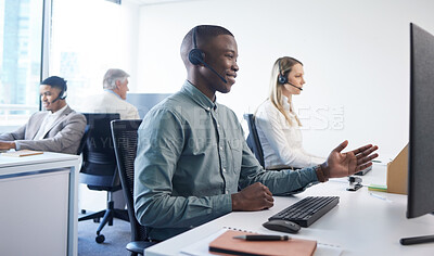 Buy stock photo Shot of a young businessman using a headset and computer in a modern office