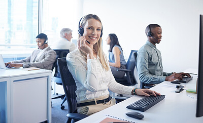 Buy stock photo Portrait of a mature businesswoman using a headset and computer in a modern office
