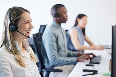 Buy stock photo Shot of a mature businesswoman using a headset in a modern office with her team in the background