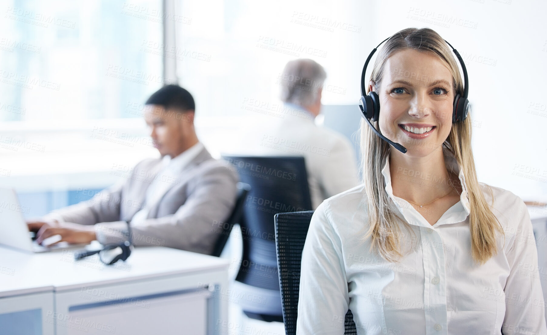 Buy stock photo Portrait of a mature businesswoman using a headset in a modern office with her team in the background