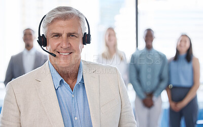 Buy stock photo Portrait of a mature businessman using a headset in a modern office with his team in the background