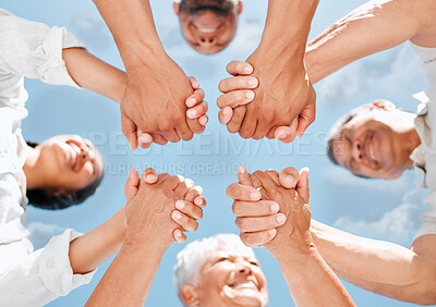 Buy stock photo Shot of a family in a huddle outside