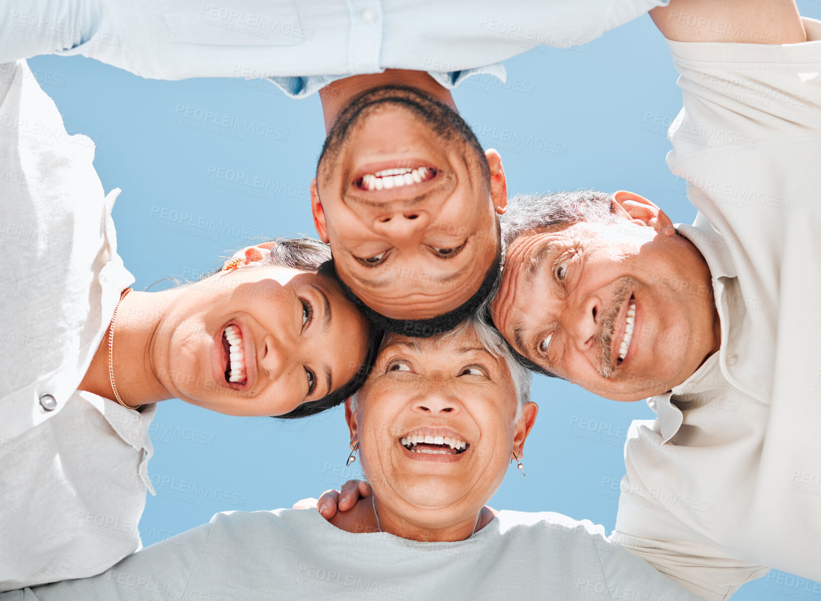 Buy stock photo Family, happy and hug outdoor for huddle, bonding and solidarity with blue sky on weekend break. People, smile and circle outside for support, relax and community with connection, trust or low angle