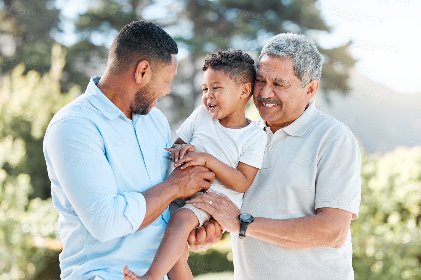 Buy stock photo Shot of a little boy posing outside with his father and grandfather