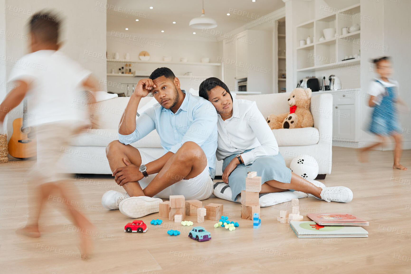 Buy stock photo Living room, running and parents with stress, kids and tired with burnout, anxiety and noise in home. Mother, father and energetic children in lounge with adhd, fatigue and motion with headache