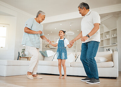 Buy stock photo Dancing, grandparents and child in lounge for connection, bonding together and family for fun in home. Senior people, kid and affection with love, support and happiness for trust, comfort and growth
