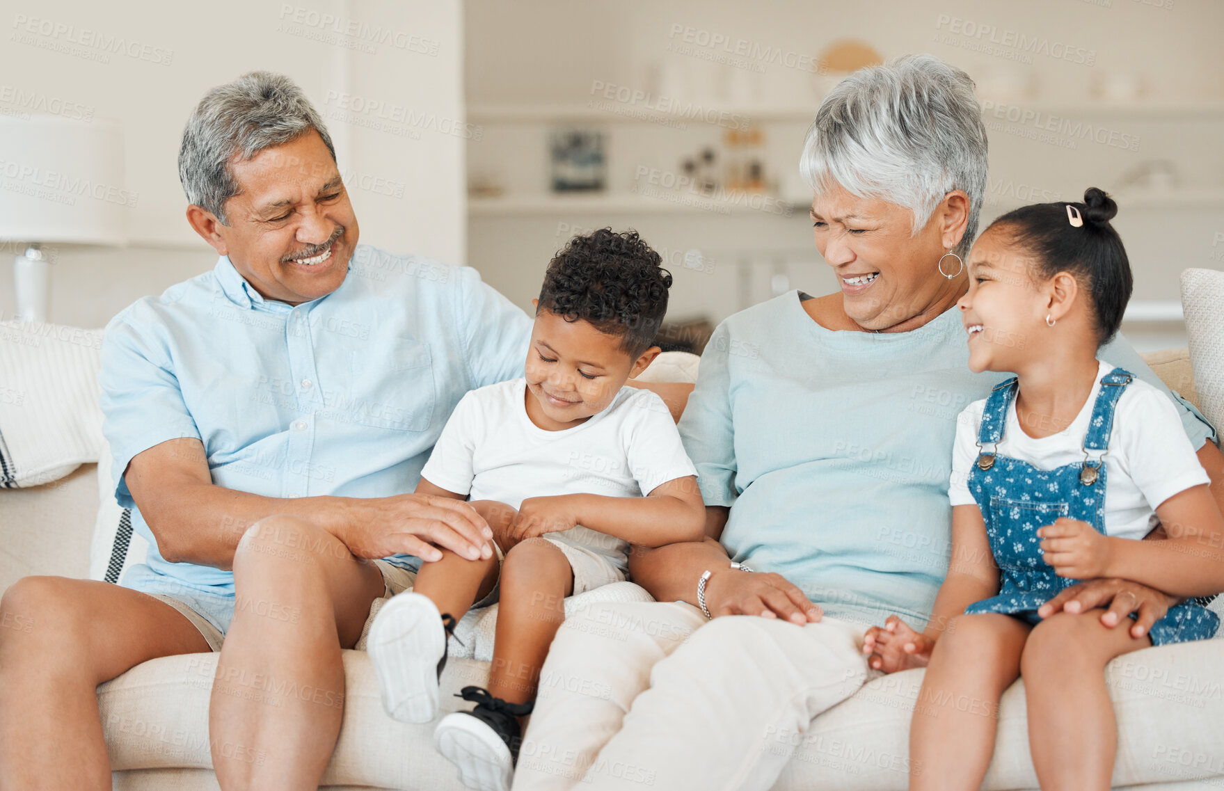 Buy stock photo Laughing, family and smile in home, bonding and fun in living room on house sofa. Grandparents, couple and happy grandchildren with grandmother and grandfather for love, relax and together in lounge