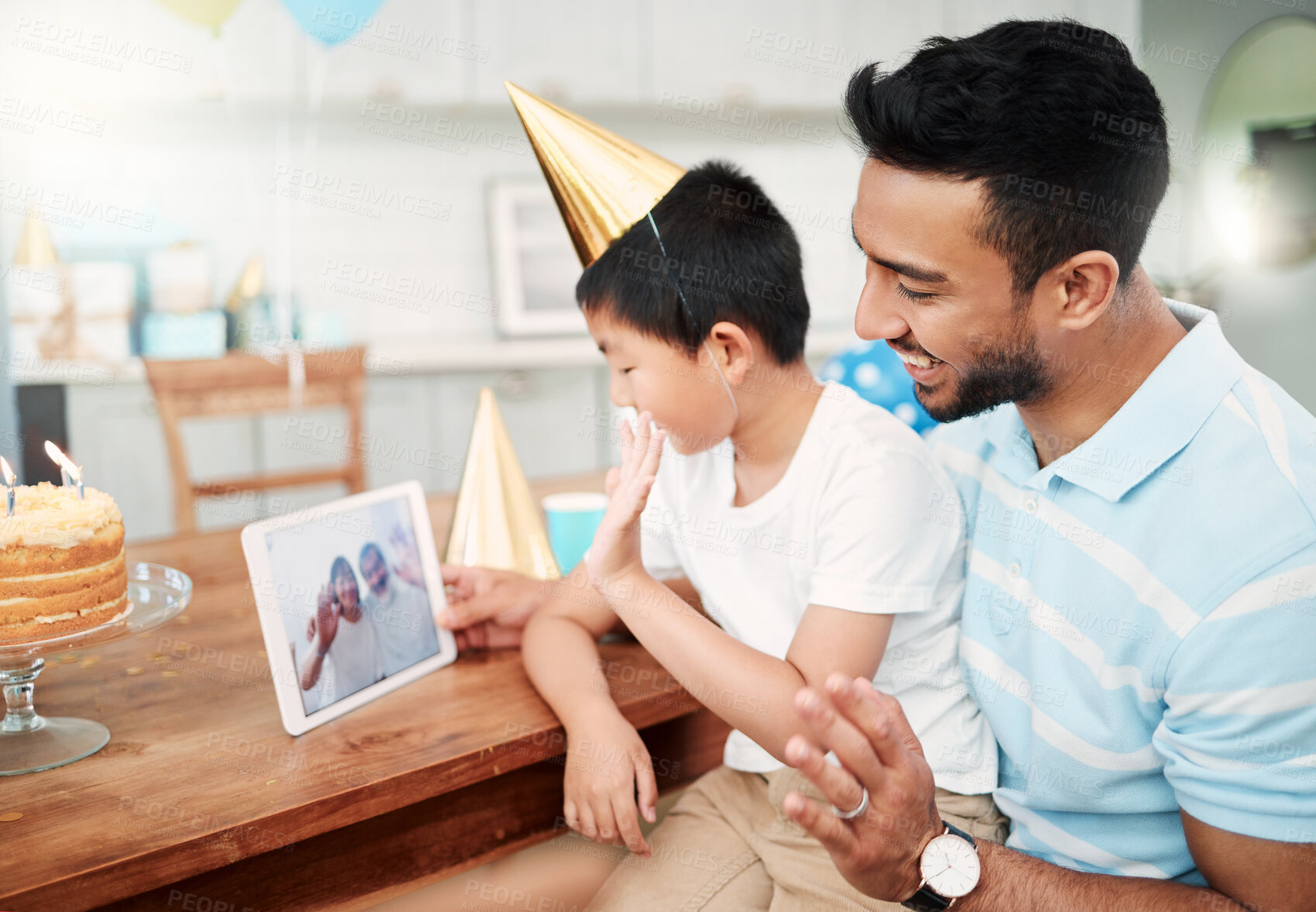 Buy stock photo Shot of a father and son using a digital tablet together at home