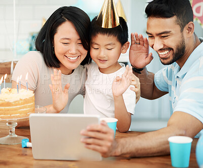 Buy stock photo Shot of a happy family using a tablet at home