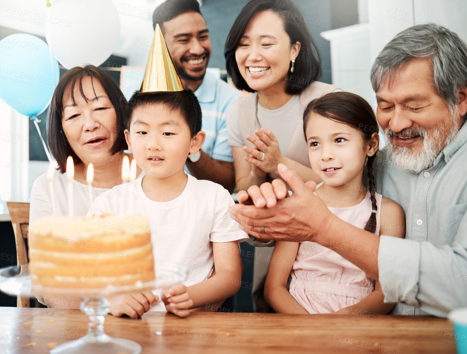 Buy stock photo Shot of an adorable little boy celebrating a birthday with his family at home