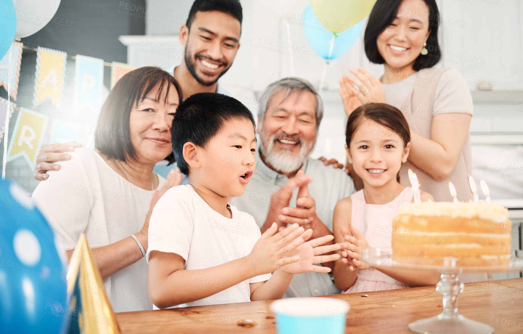 Buy stock photo Shot of an adorable little boy celebrating a birthday with his family at home