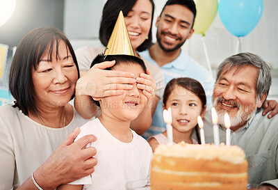 Buy stock photo Shot of a boy having his eyes covered at a birthday party at home