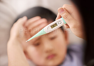 Buy stock photo Cropped shot of a woman checking her son's temperature with a thermometer