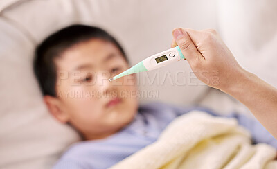 Buy stock photo Cropped shot of a woman checking her son's temperature with a thermometer