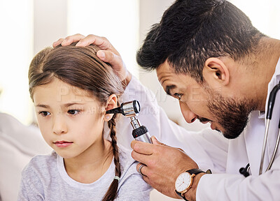 Buy stock photo Shot of a doctor using an otoscope to examine a little girl's ear