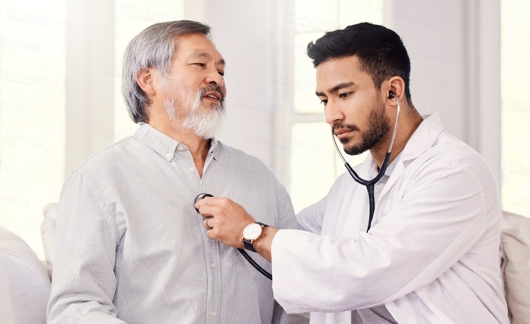 Buy stock photo Shot of a doctor listening to a senior man's heartbeat during a checkup