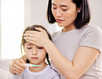 Buy stock photo Cropped shot of a woman checking her sick child's temperature