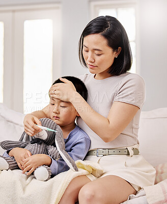 Buy stock photo Cropped shot of a woman checking her sick child's temperature