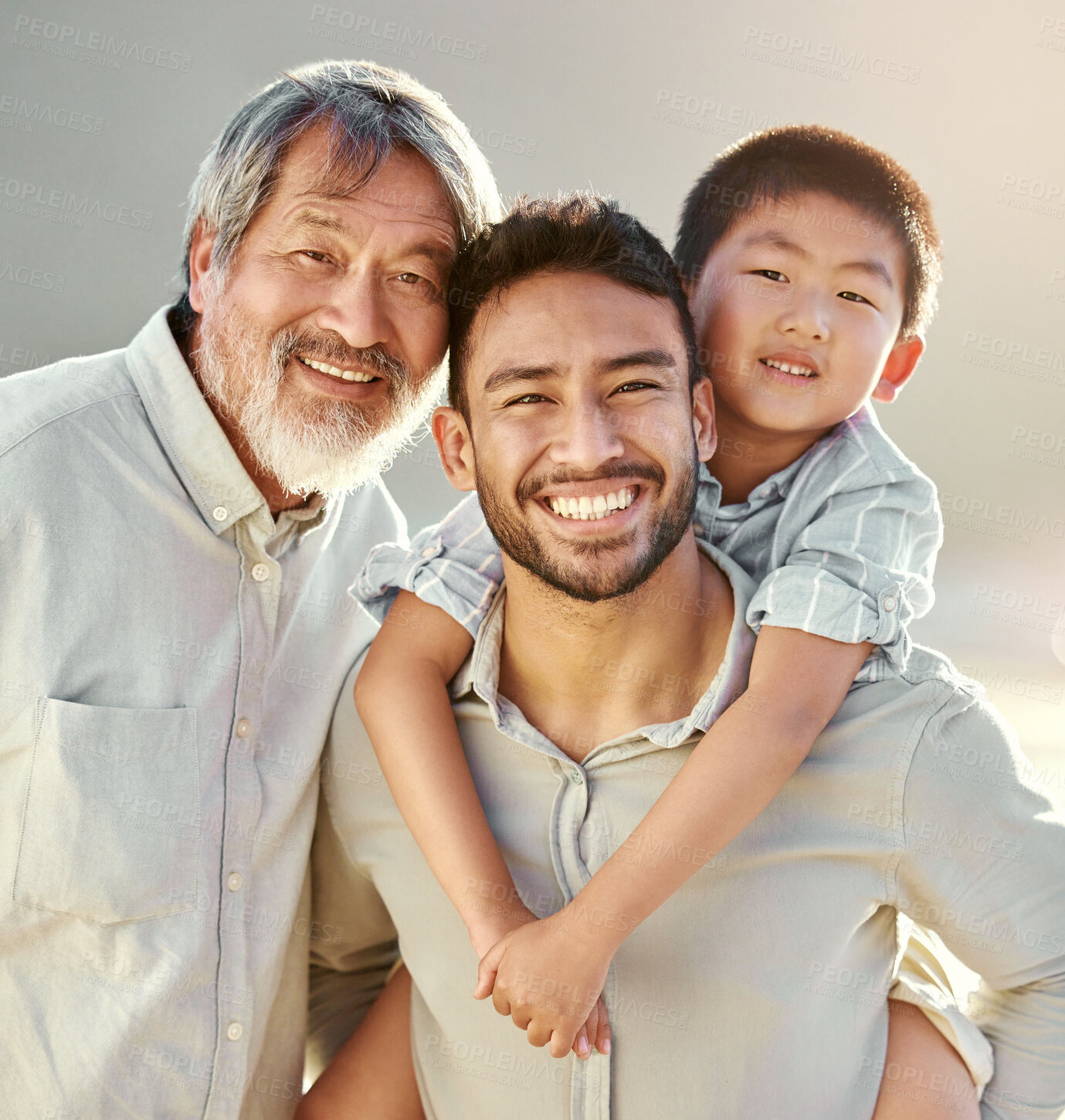 Buy stock photo Cropped portrait of a handsome young man on the beach with his father and son