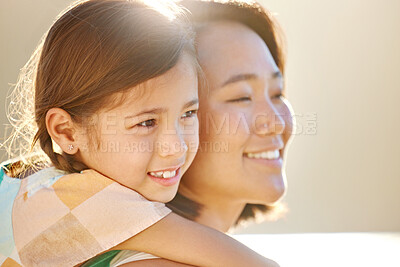 Buy stock photo Cropped portrait of an attractive young woman piggybacking her daughter on the beach