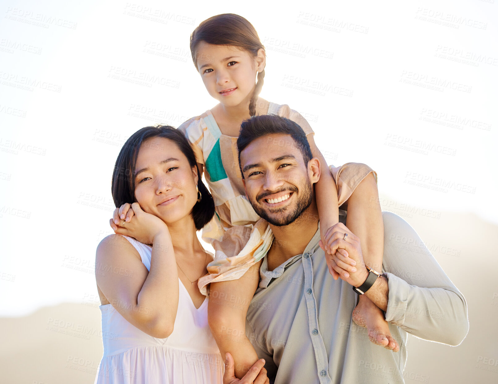 Buy stock photo Cropped shot of a happy diverse family of three at the beach