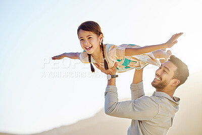 Buy stock photo Cropped shot of a handsome young man playing with his daughter on the beach