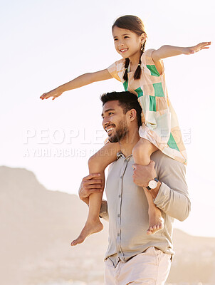 Buy stock photo Cropped shot of a handsome young man carrying his daughter on his shoulders at the beach