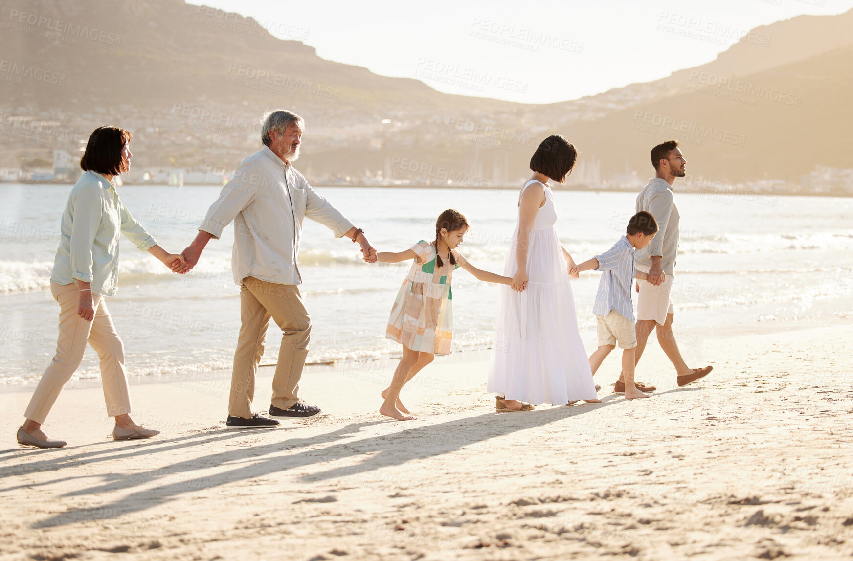 Buy stock photo Full length shot of a happy diverse multi-generational family at the beach