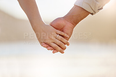 Buy stock photo Closeup shot of an unrecognizable couple holding hands on the beach