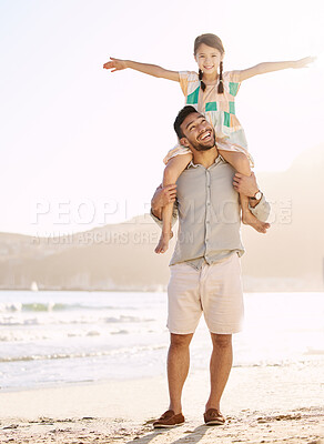 Buy stock photo Full length shot of a handsome young man carrying his daughter on his shoulders at the beach