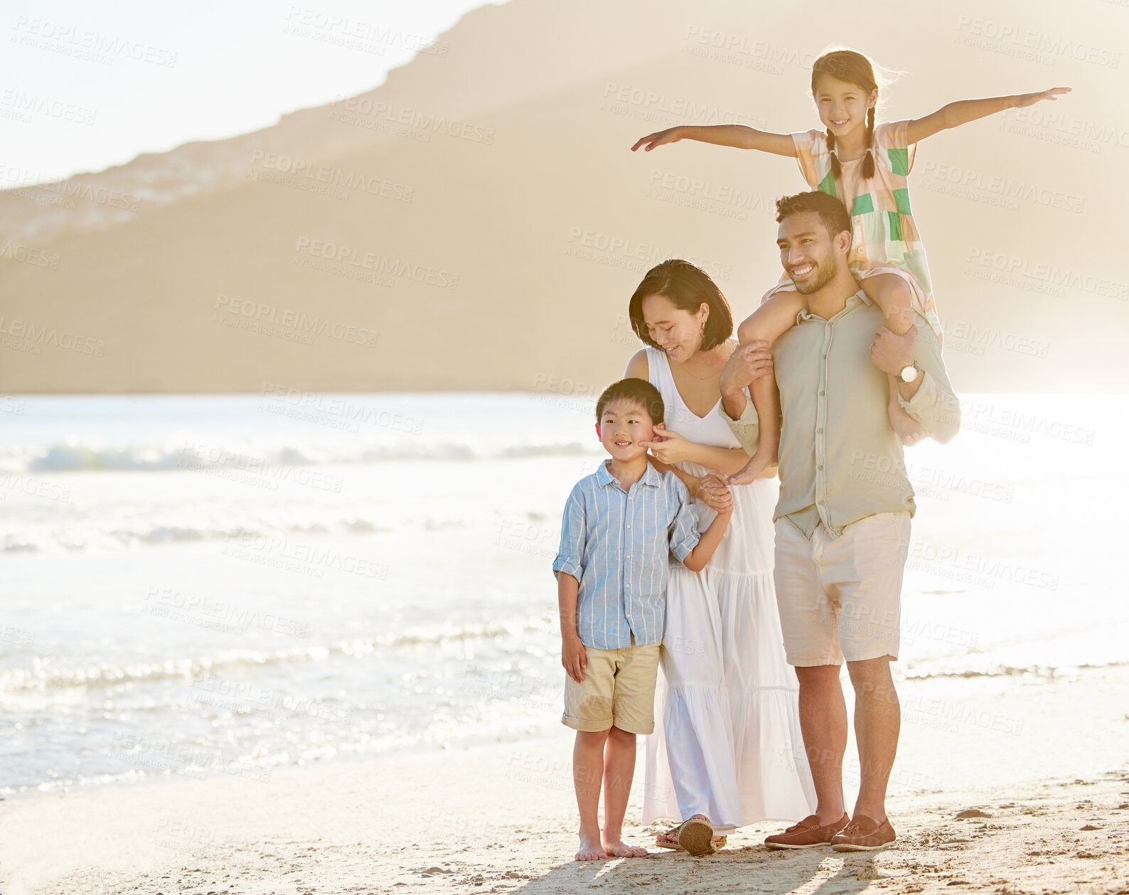 Buy stock photo Full length shot of a happy diverse family of four at the beach
