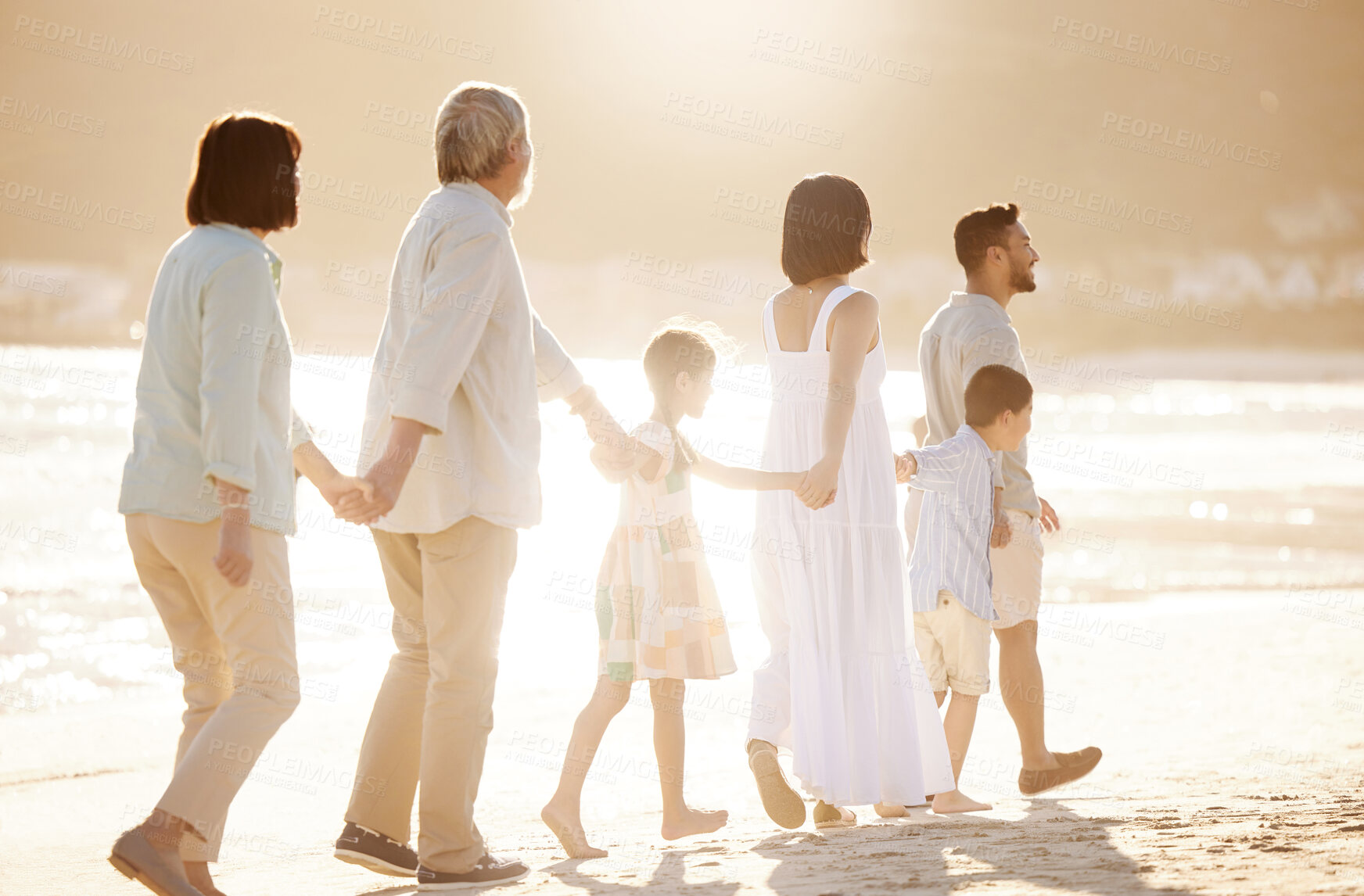 Buy stock photo Full length shot of a happy diverse multi-generational family at the beach