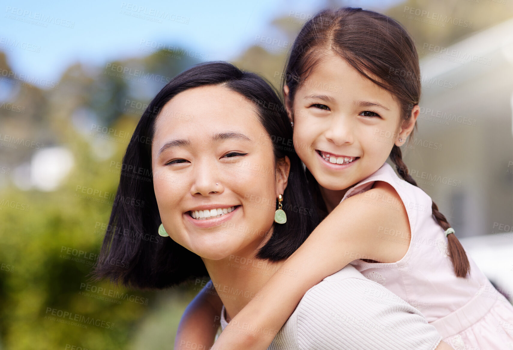 Buy stock photo Shot of a young mother and daughter spending time together in the garden at home