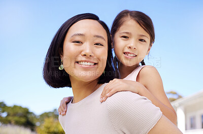 Buy stock photo Shot of a young mother and daughter spending time together in the garden at home